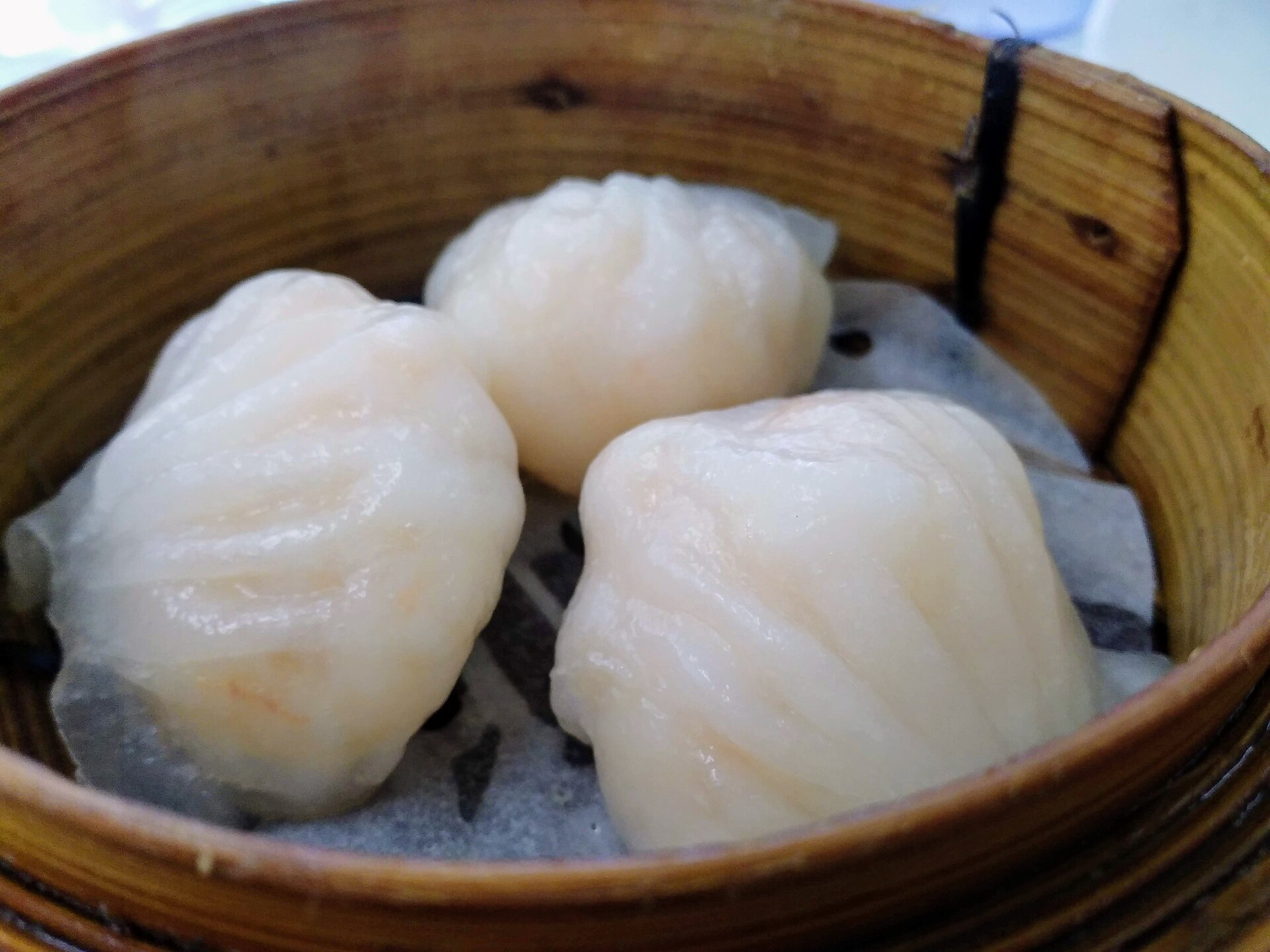 Har gow prawn dumplings in a bamboo steamer